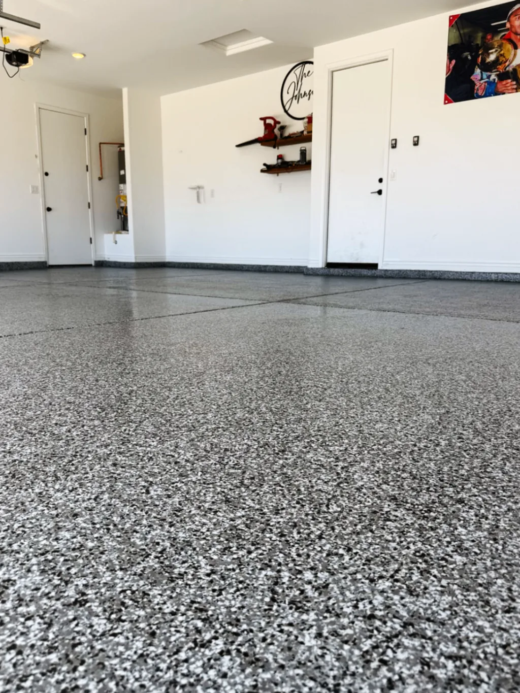 Close low-angle view of a finished garage floor showing the full-flake coating texture and coverage.