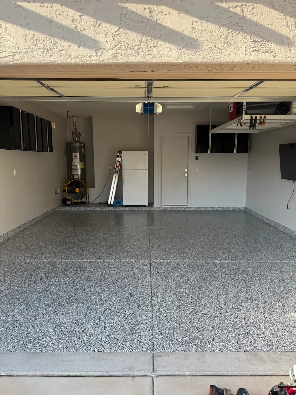 Wide view of a finished full-flake garage floor coating with a bright, even finish.