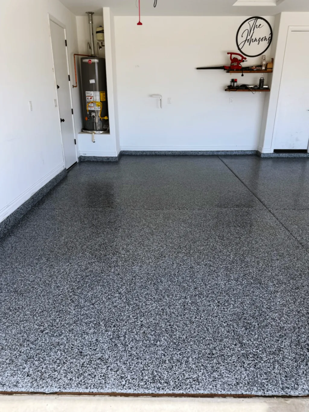 Finished garage coating with a full-flake surface photographed from the front edge of the slab.